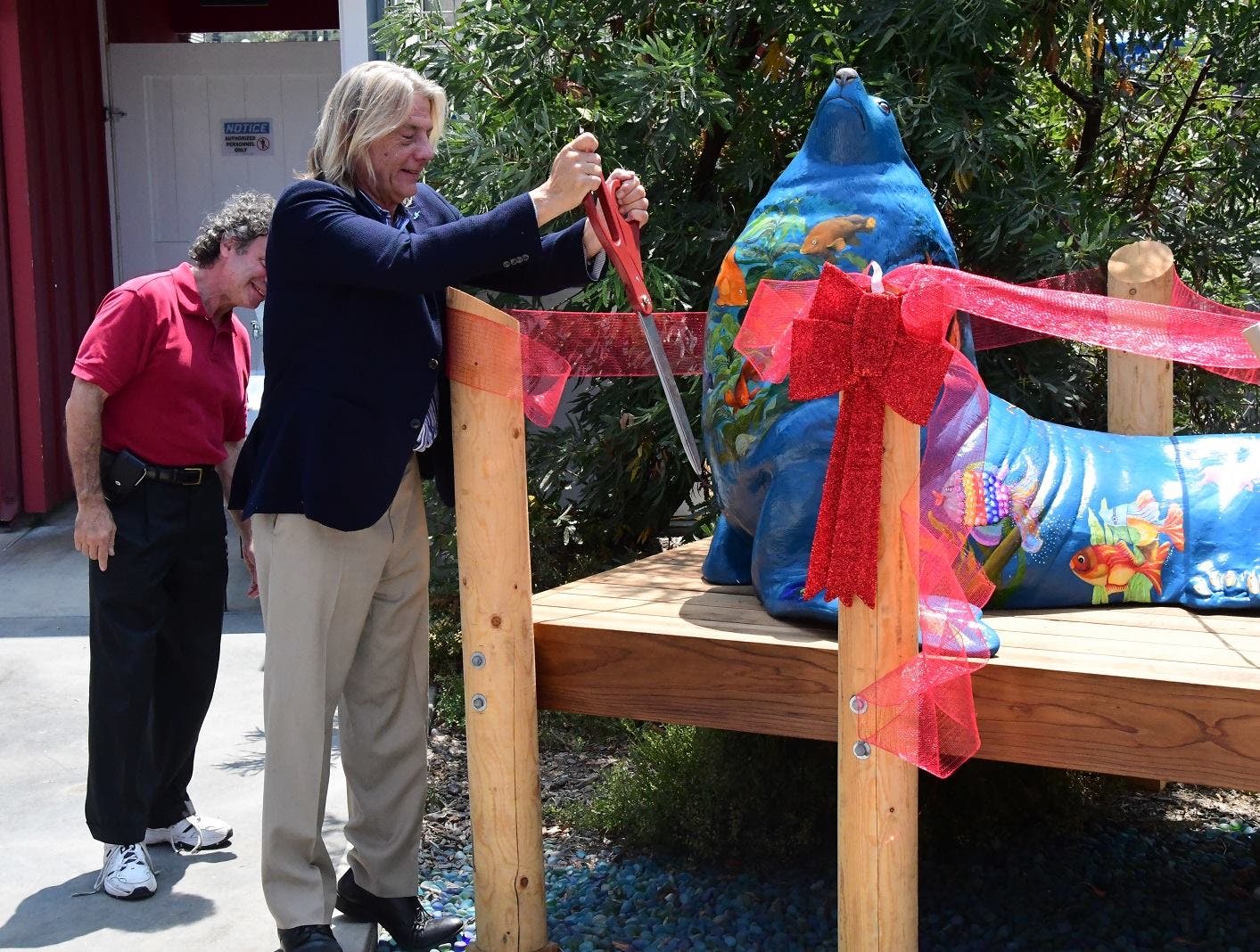 Director Keith Matassa cuts the ribbon for Seamore the sea lion sculpture Director Keith Matassa cuts the ribbon for Seamore the sea lion sculpture