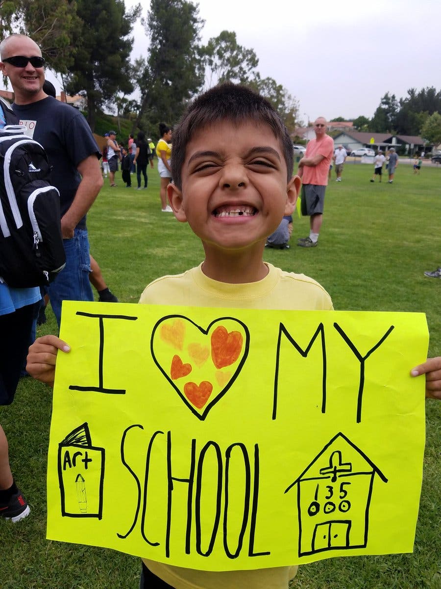 Quail Summit Elementary first grader Riley Robertson shows his support of District of Choice program.