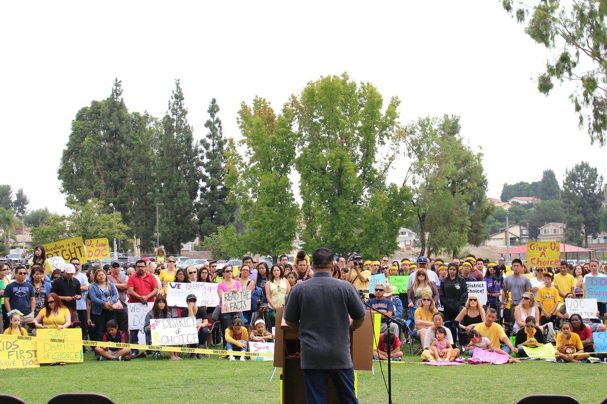 Parent Sam Castorena address the crowd during a District of Choice rally.