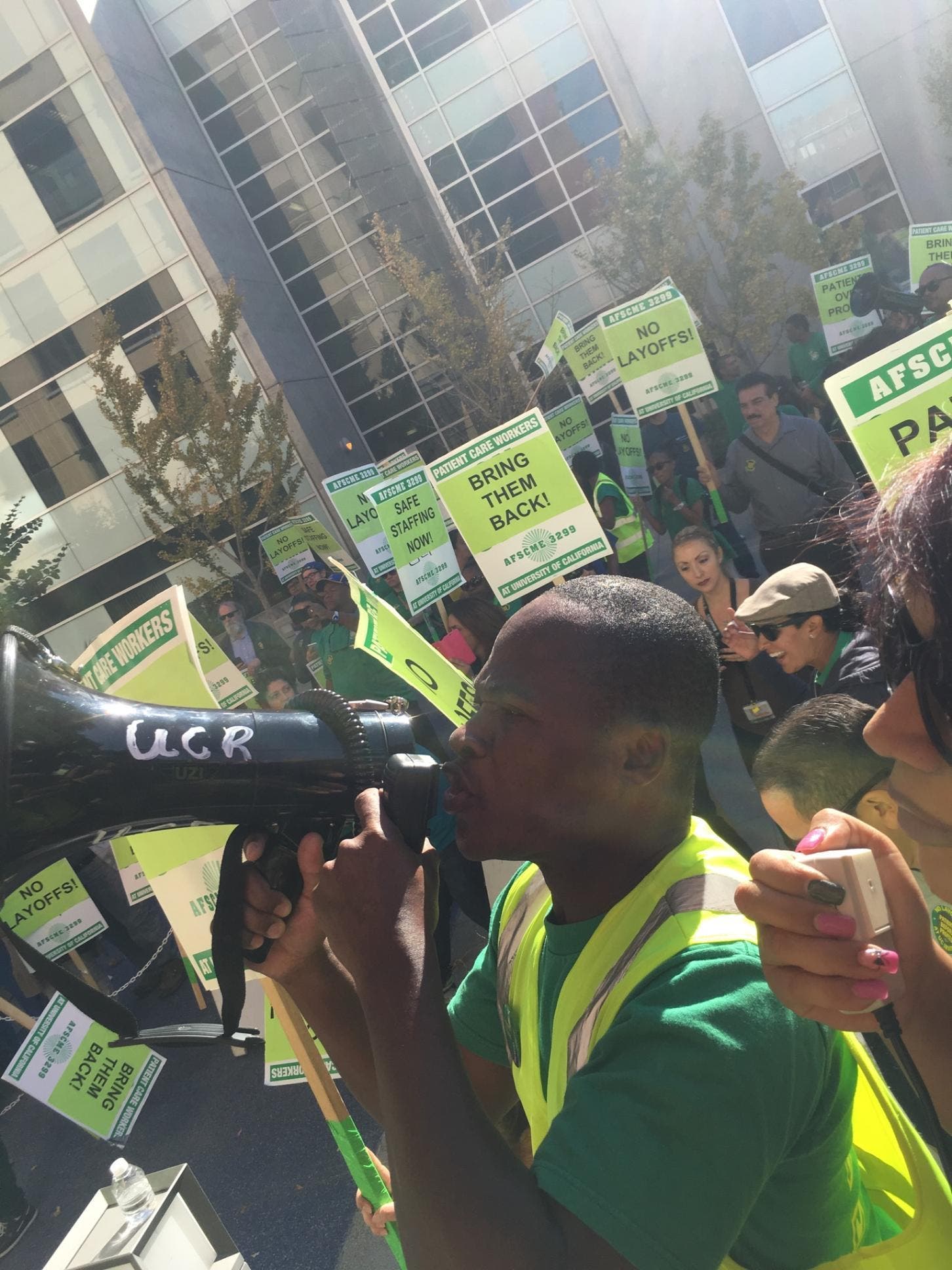 Patton Gondo led the protesters in the rally, with signs saying "Bring them Back" and "Safe Staffing Now!" (T. Stenhouse, photo)