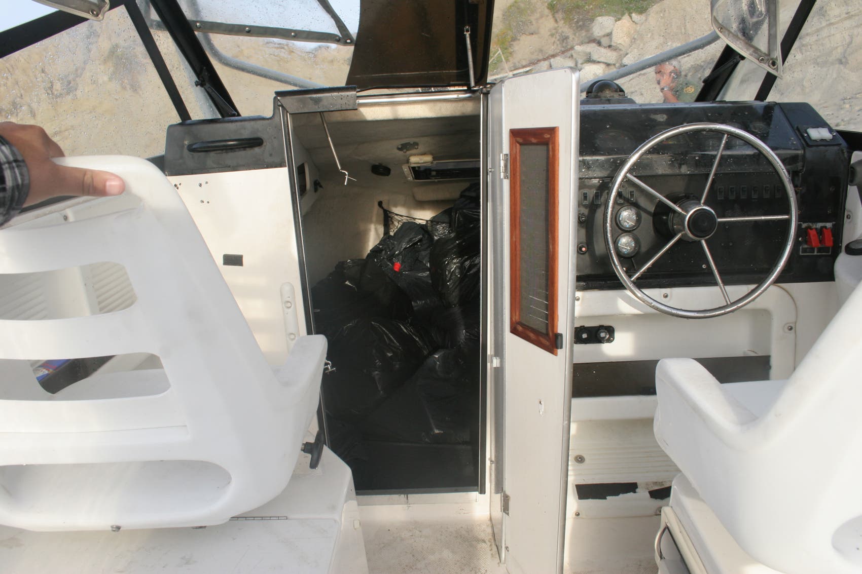 The bundles of marijuana were stashed in black plastic bags located beneath the bow and on the deck. The bundles of marijuana were stashed in black plastic bags located beneath the bow and on the deck.