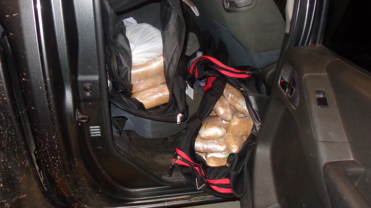 Sixty-one bundles of narcotics were bundled up inside three duffel bags in the truck’s cab. Sixty-one bundles of narcotics were bundled up inside three duffel bags in the truck’s cab.