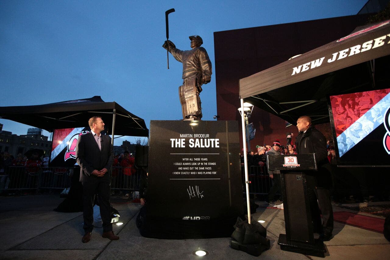 Martin Brodeur admires a new statue honoring his career.
