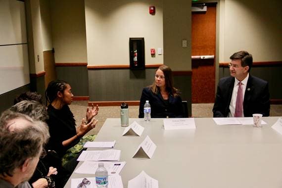 Rep. Schneider listens to Jessyca Dudley, Gun Violence Prevention Officer at the Joyce Foundation at Monday's roundtable.