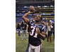 New England Patriots free safety Sergio Brown throws a ball back into the stands after signing an autograph for a fan on Media Day during Super Bowl week on January 31, 2012 in Indianapolis. 