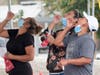 People take coronavirus test at a mobile Coronavirus testing site at Martin Luther King Jr. Community Hospital Tuesday, Aug. 4, 2020, in Los Angeles.