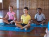 School,Kids,Meditating,During,Yoga,Class,In,Basketball,Court,At
