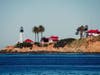 A lighthouse stands majestically in the middle of a vast body of water, located in the Point Loma peninsula of San Diego, California.