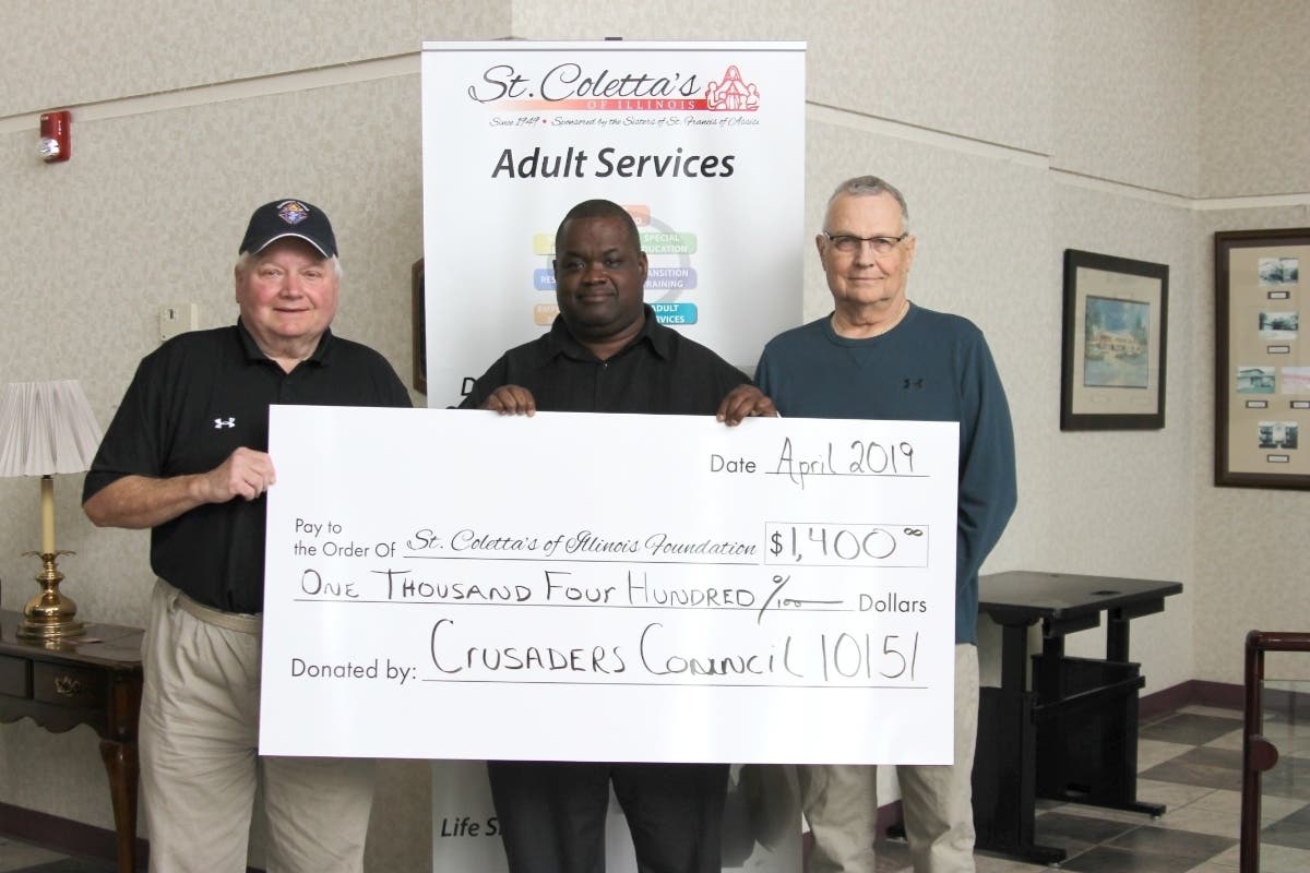 Grand Knight George Griffin (L) and Council Trustee Len Walejeski (R) present a check to Ray Bryan at St. Coletta's. 