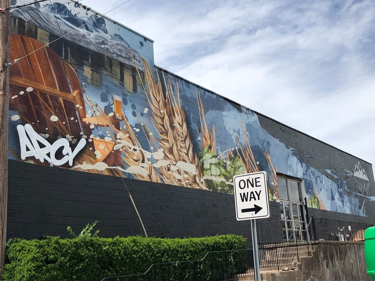 Workers are putting the finishing touches on a mural at the site of a new brewhouse in Manchester.