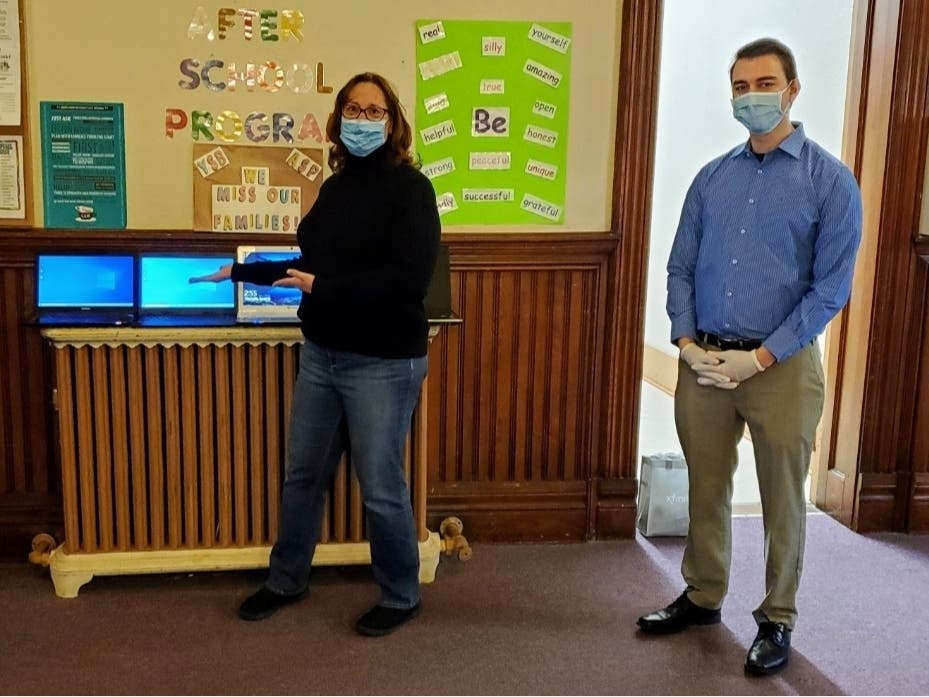 Vernon Town Council member Laura Bush and Chris MacCoy owner of MacCoy Technology with donated computers. 