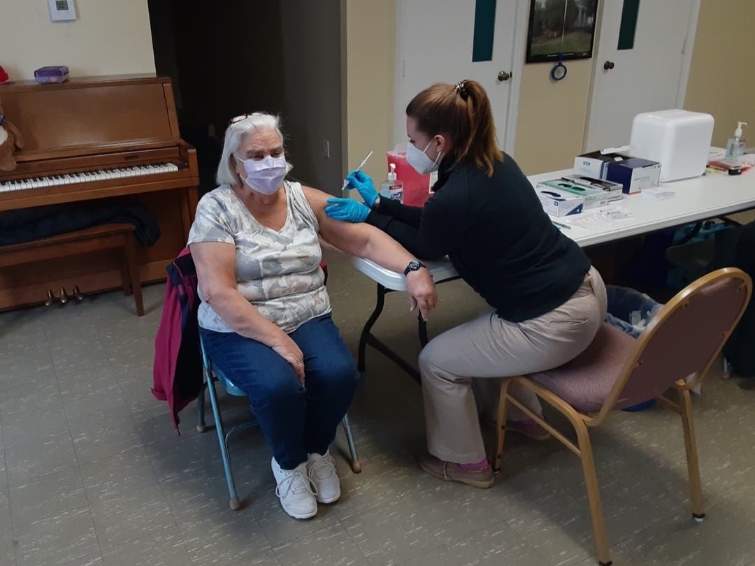Judith Johnston gets a coronavirus shot at the First Congregational church of Vernon Thursday.