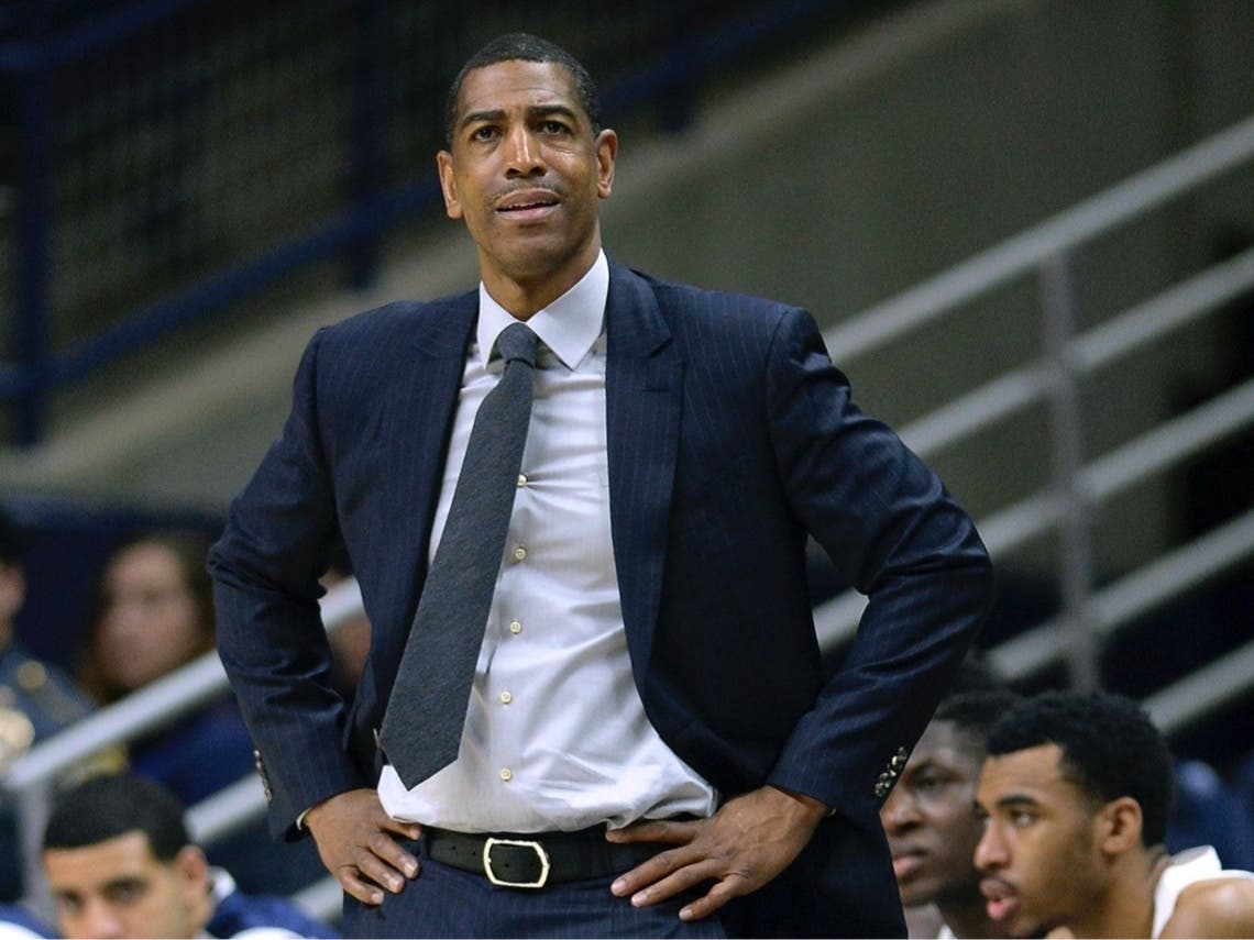 An independent arbiter has ruled that UConn improperly fired former men's basketball coach Kevin Ollie and must pay him more than $11 million.