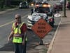A fire policeman with the Vernon Fire Department helps re-route traffic at the scene of a collision on Union Street this evening.