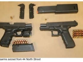 Guns were seized while a warrant was being served in Manchester Thursday. 
