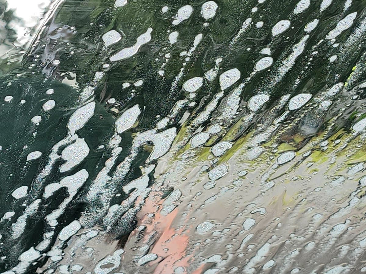 A bunch of eager high school football players attack a Nissan with soap and hoses in 90-degree heat to earn cash for their program.