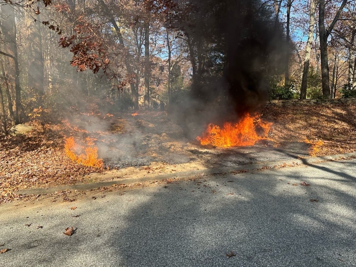 Tolland firefighters reacted quickly to a lawn tractor that burst into flames near a large leaf pile Monday. 