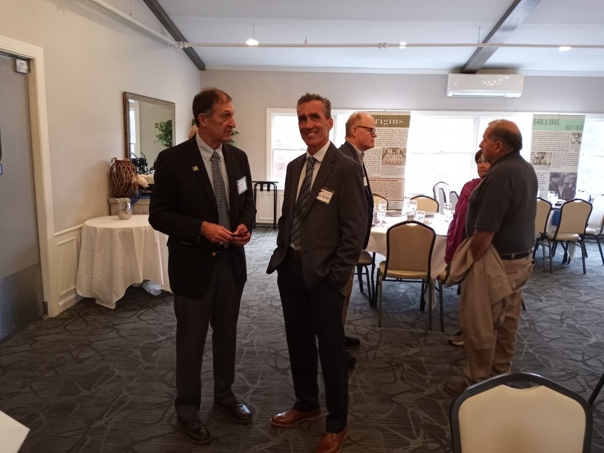 Famed Irish Runner Mark Carrol (right) takes a moment Thursday to reminisce about his experiences with Manchester Road Race Committee President Dr. Tris Carta. The two-time winner is back as the 2024 honorary chairman.  