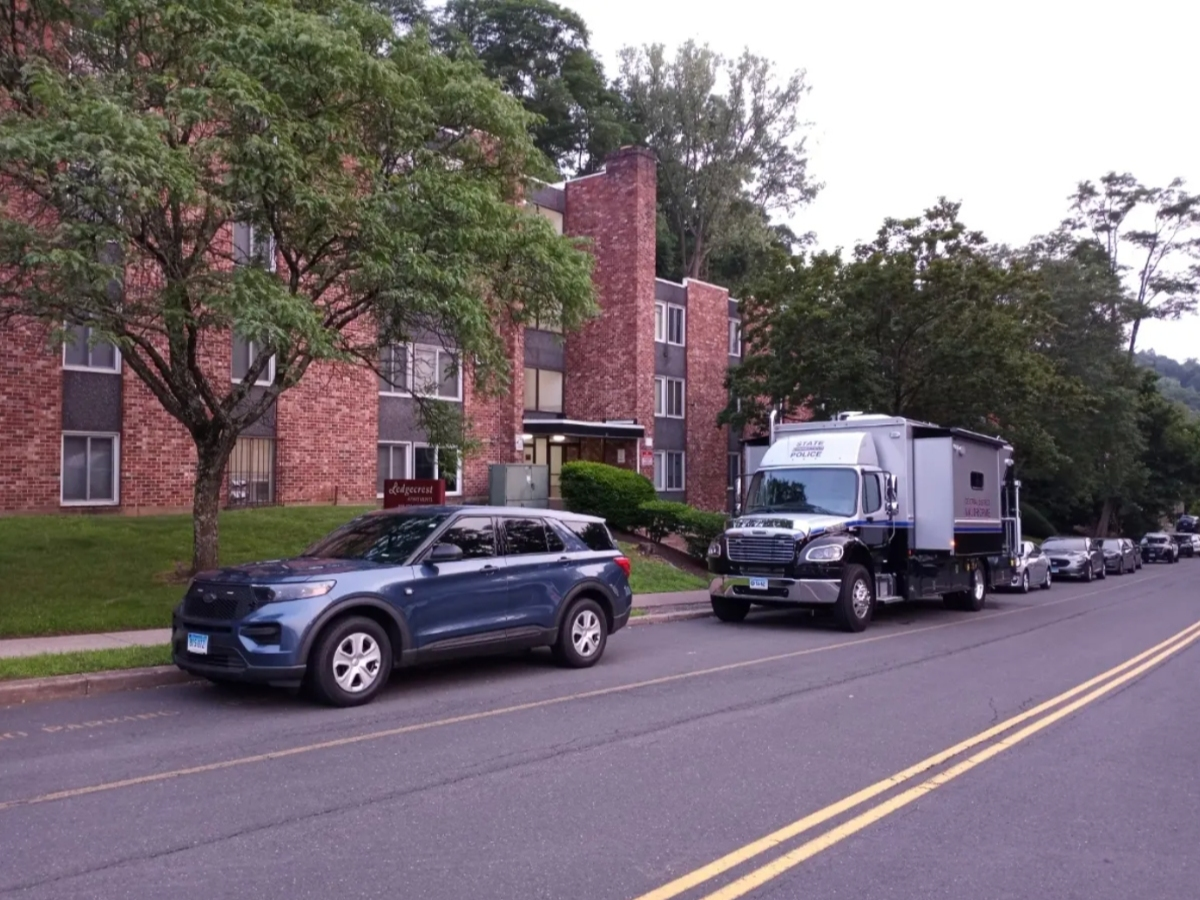 A state police forensics truck sits outside a Vernon apartment building in 2023, where a 22-year-old woman was found dead.