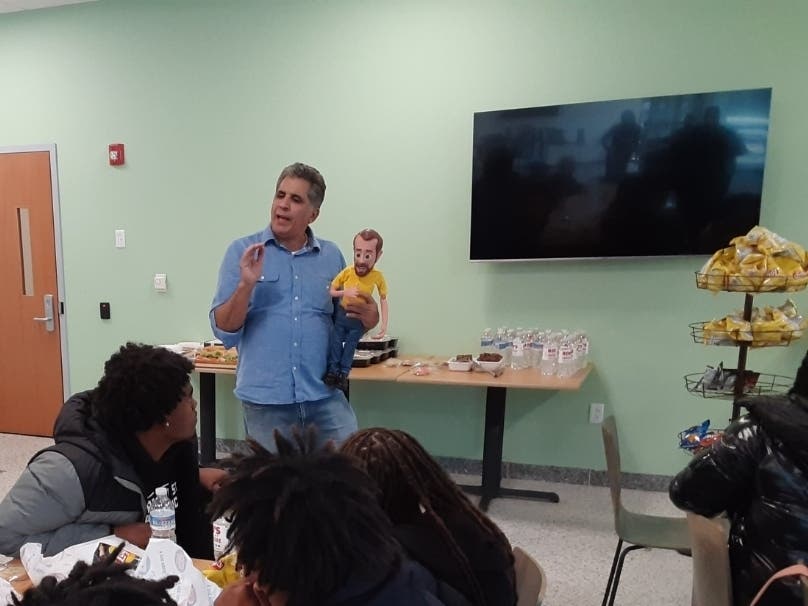 Bob's Discount Furniture creative director Michael Bannon explains the commercials with Little Bob at an educational event at the Manchester headquarters.