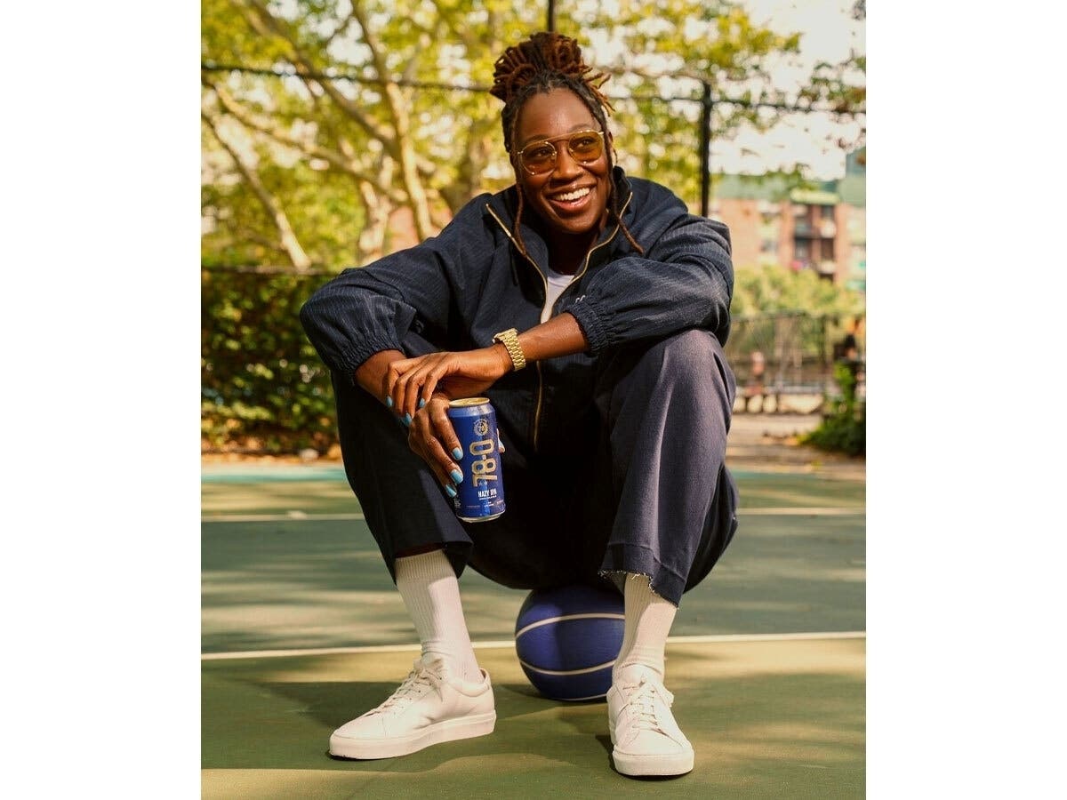 Tina Charles poses with 78-0 Hazy IPA.