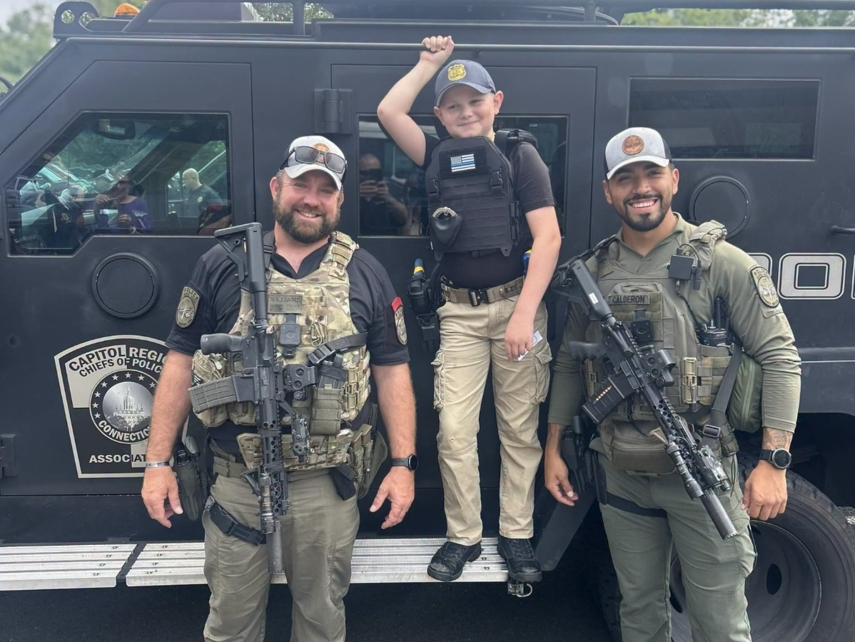 Collin Genetti with the MPD's Sgt. Dave Williams and Sgt. Johan Calderon.