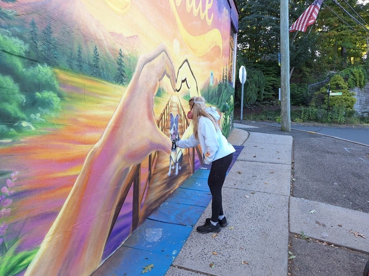 Heather Herindeen works on the Rockville mural Thursday morning. (Chris Dehnel/Patch)