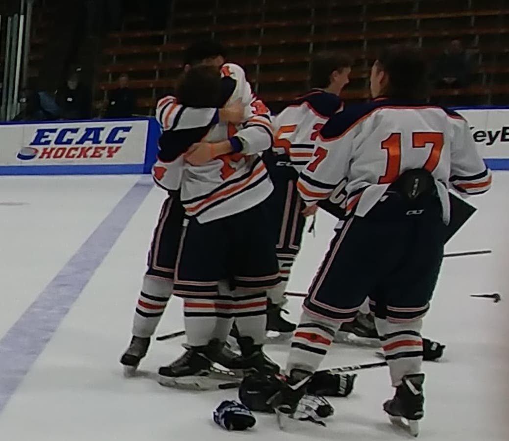 Lyman Hall co-op players celebrate the program's first ice hockey championship after defeating Sheehan.