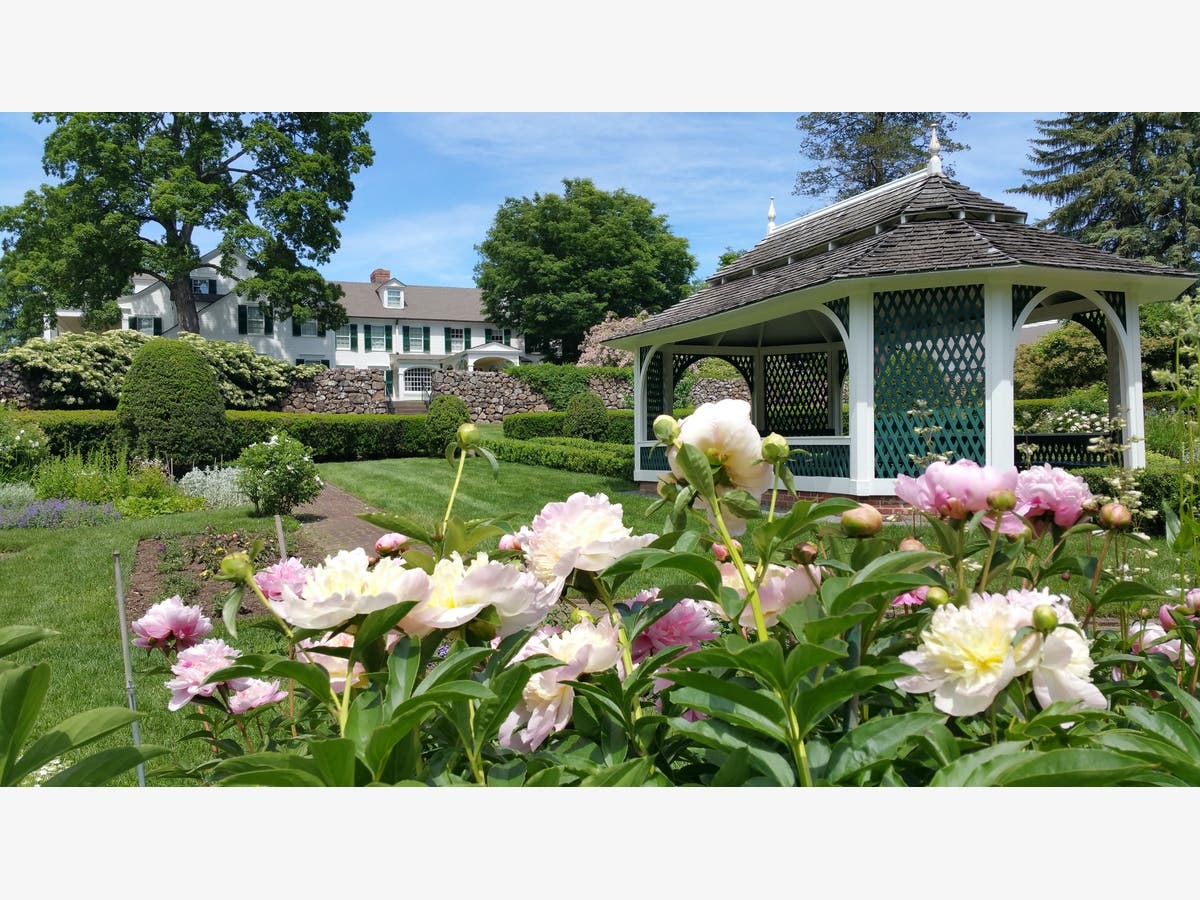 The summer house and main house of the Hill-Stead Museum, as seen from the Sunken Garden.