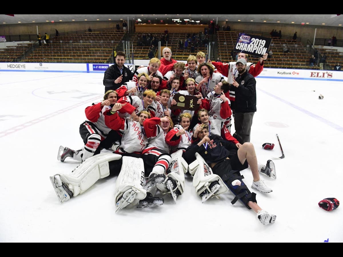 Branford players celebrate the school's first ice hockey state title since 1988.