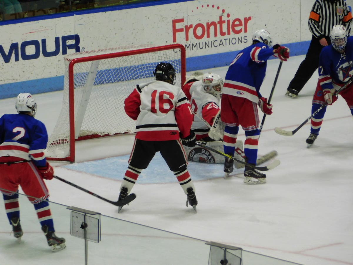 Glastonbury puts pressure on Branford goaltender Jared Yakimoff.