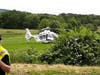 A medical helicopter stands by in a field on nearby Hoffman Road.