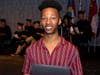 Justin Lipscomb receives the Outstanding Achievement in Journalism Award from American International College.