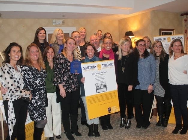 The 1987 Simsbury High School Class L championship girls soccer team upon its induction into the Simsbury Trojans Hall of Fame.