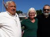 Cookie Bromage is flanked by Mike and Steve Angelica at the Enfield High School stadium and field dedication ceremony Saturday.