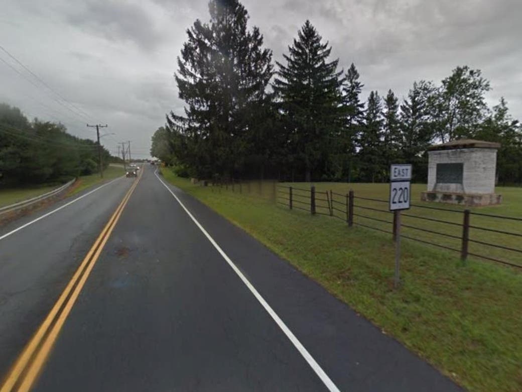 Route 220 at the original Shaker Cemetery in Enfield, across from the Carl Robinson Correctional Institution. In 1917, all headstones were removed and replaced with one monument with no names listed on the monument. 