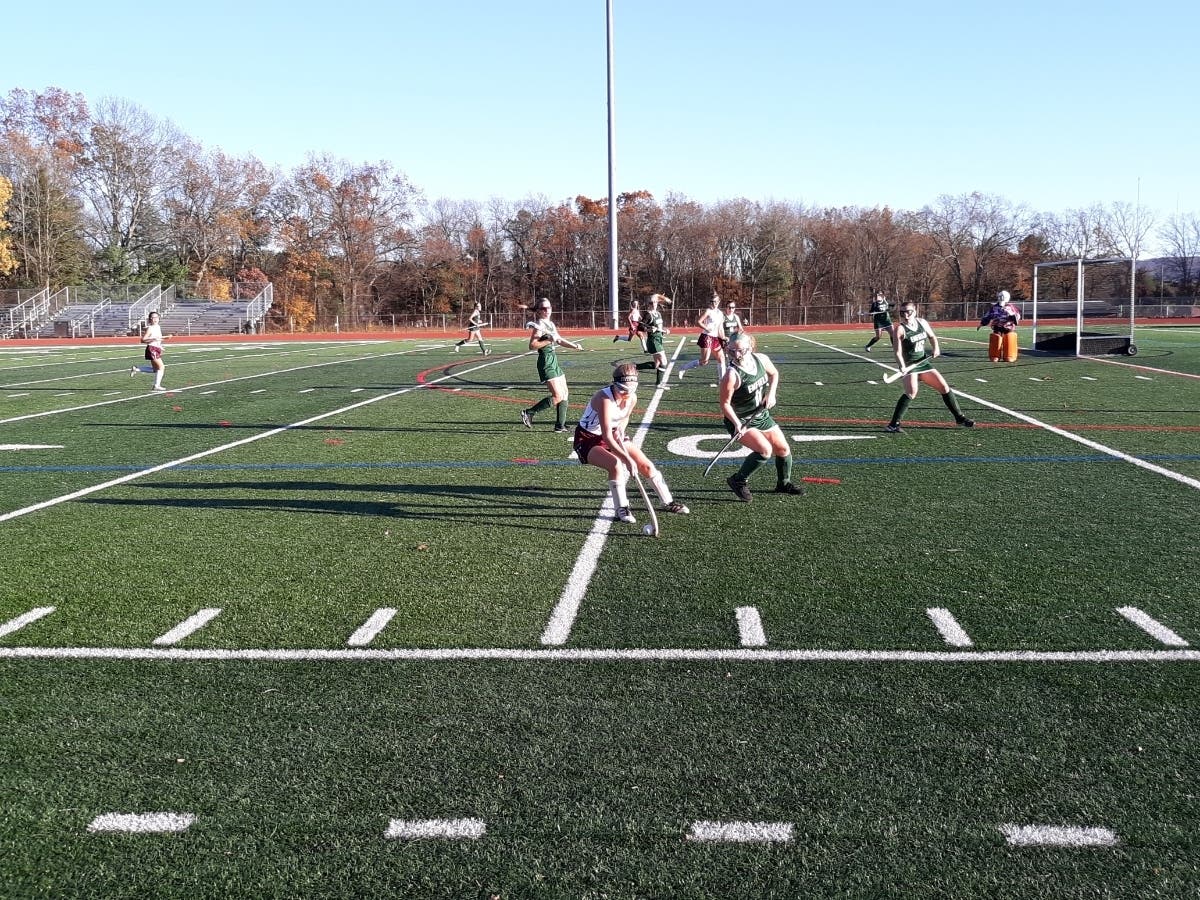 Delaney Dopp of Farmington breaks in on Enfield defender Reilly Reim.