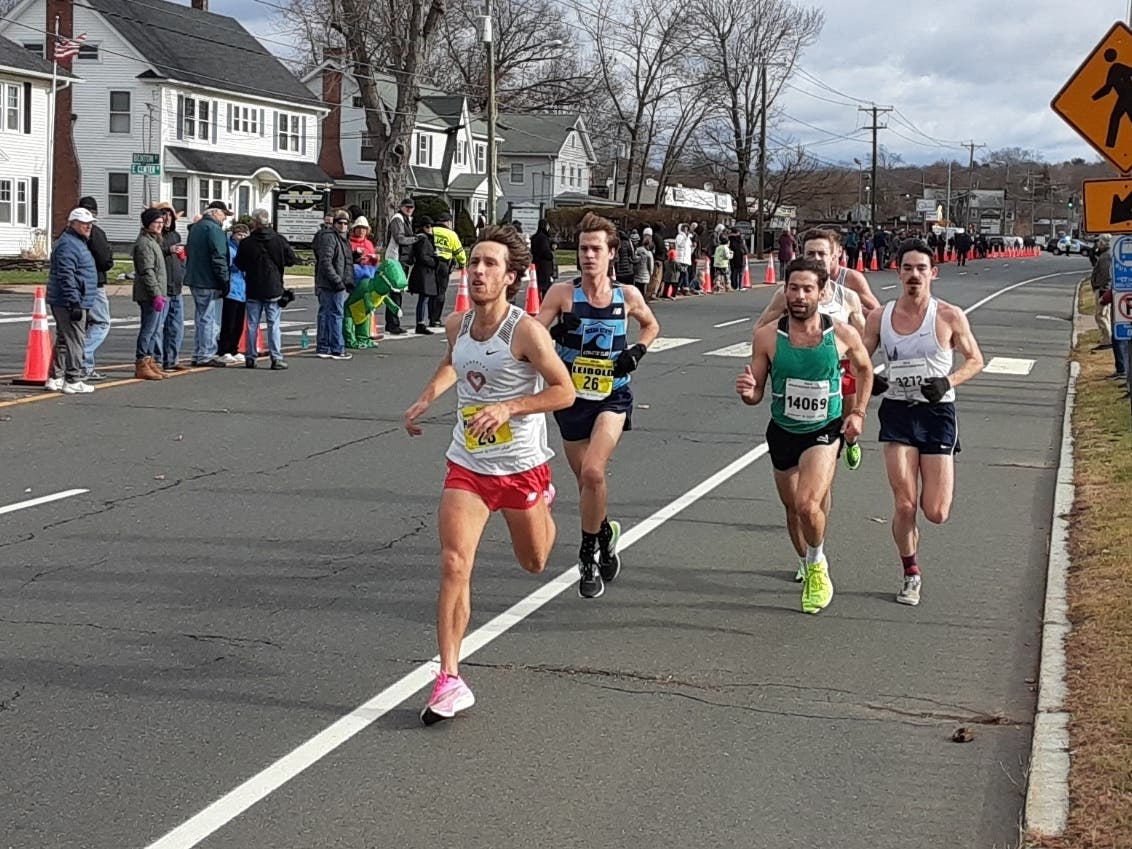 Everett Hackett (shown in front of pack at the 2019 Manchester Road Race) qualified Sunday for the 2020 Olympic Marathon Trials.