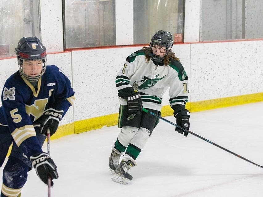 Kilian Ranger of the Newington co-op skates out of the corner, pursued by Enfield's Kyle Cox.