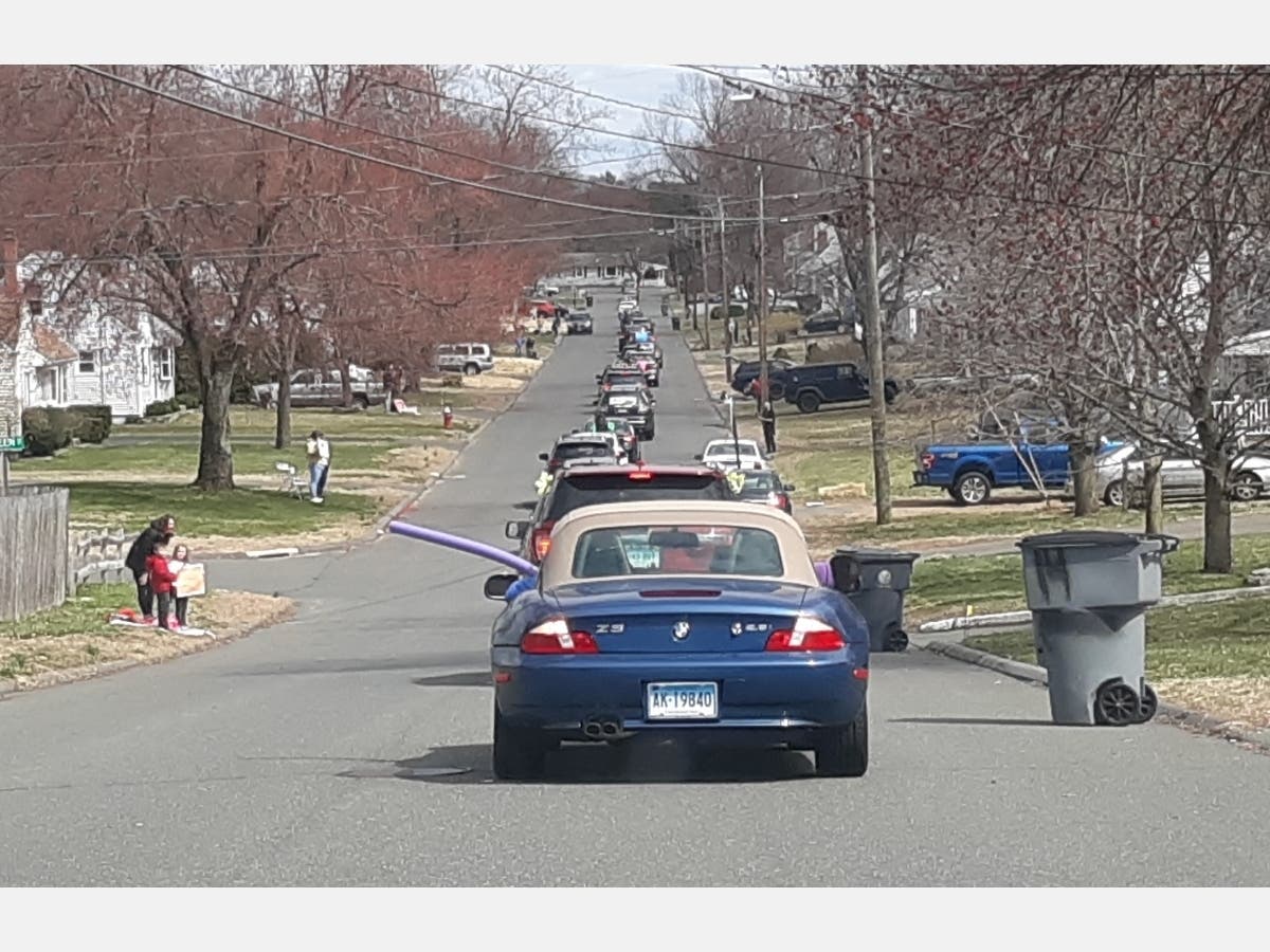 The caravan snakes its way through a neighborhood in the Raffia Rd. area.