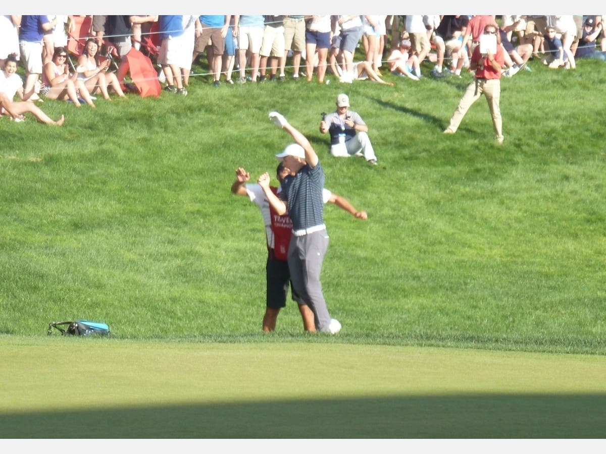 Jordan Spieth and caddie Michael Greller celebrate Spieth's tournament-winning bunker shot in a playoff in 2017.