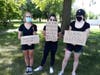 Three young ladies make their feelings known.