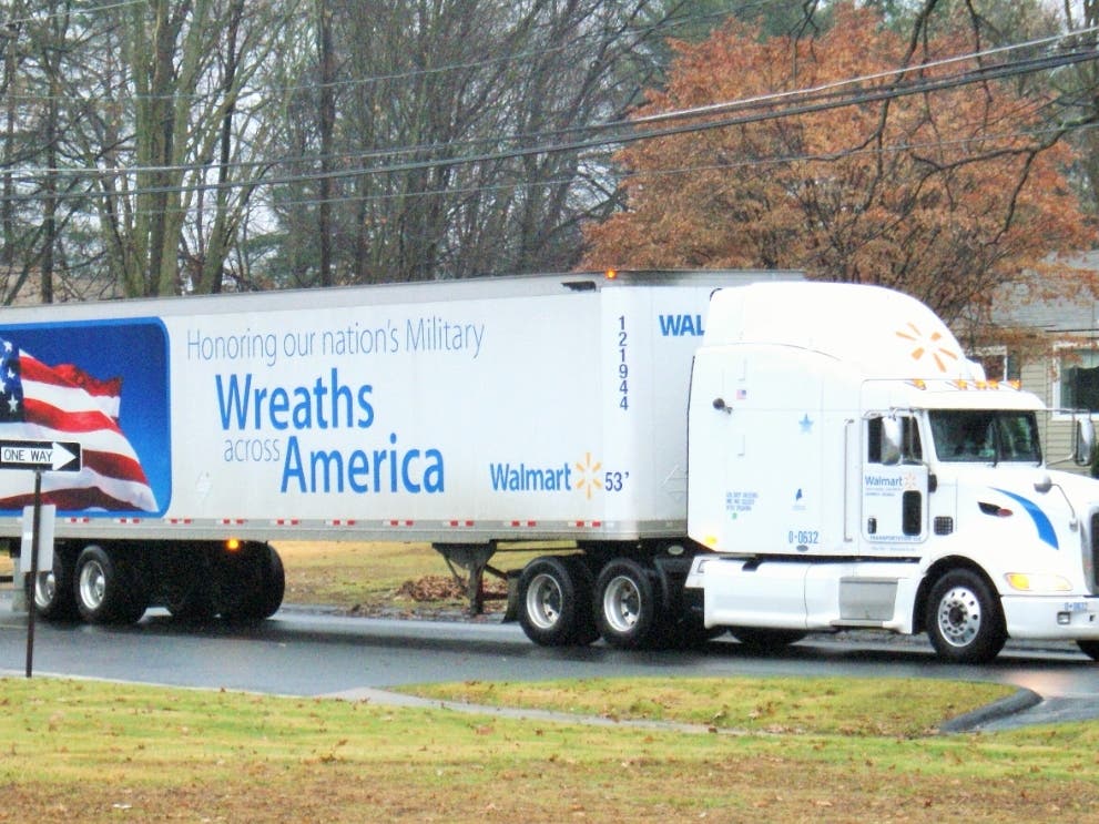 Several Walmart trucks loaded with wreaths bound for Arlington National Cemetery will be passing by every public school in Enfield Wednesday morning.