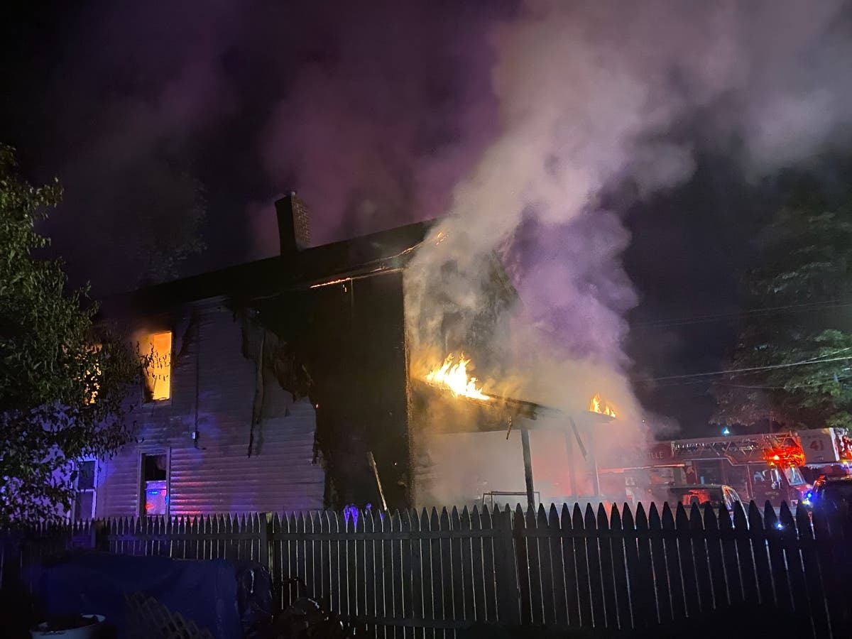 Firefighters work at a residence on Lincoln Street in the Thompsonville section of Enfield.
