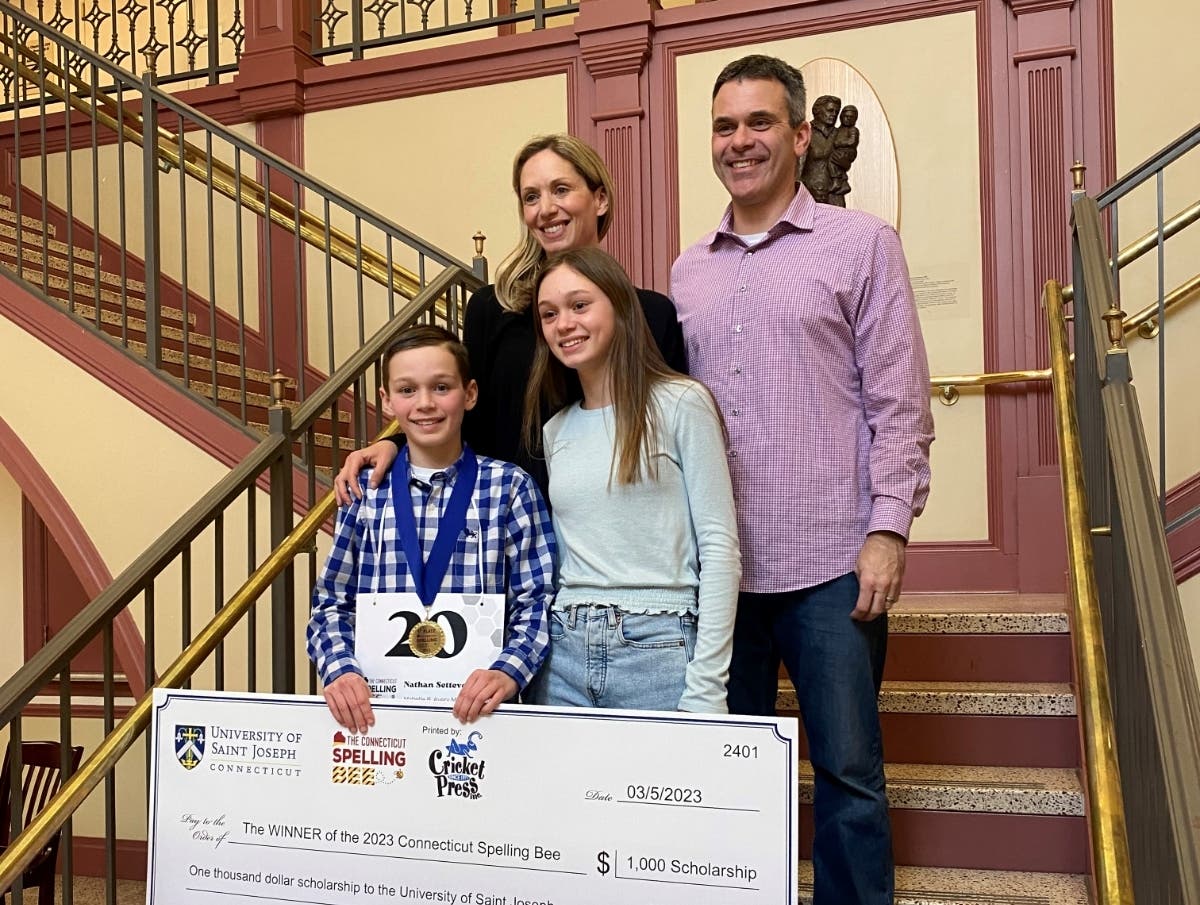Mabelle B. Avery Middle School student and 2023 Connecticut Spelling Bee champion Nathan Settevendemie with his family.
