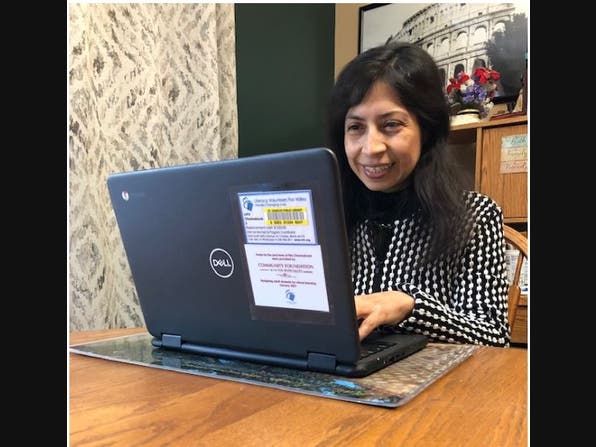 Margarita Jimenez prepares a computer for student use.
