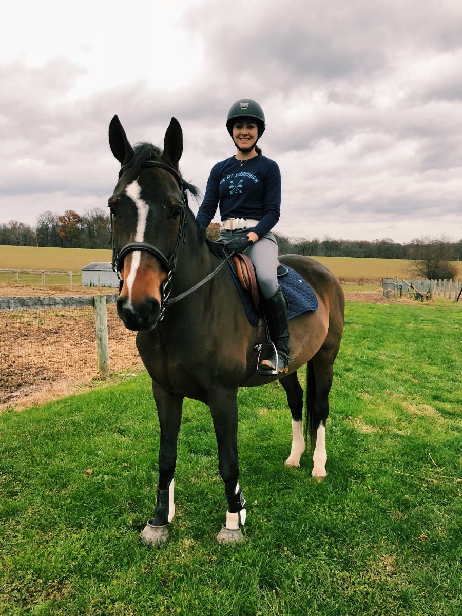  Lauren Mahr, equestrian fitness/nutrition consultant sports her logo t-shirt (The Fit Equestrian) while riding. 