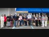Laura’s BBQ Waterfront Smokehouse owners Lloyd and Laura Adams (center) with elected officials and other local representatives during the October 22 ribbon-cutting ceremony to celebrate the restaurant’s Grand Opening.