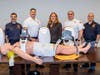(From left) Roslyn Rescue EMS Captain Joshua Schnitzer, Department Chief Jordan Williams, Nassau County Legislator Delia DeRiggi-Whitton, President Salvatore Mirra and EMS Captain Ian Newman during a demonstration on how the new LUCAS CPR devices operate.