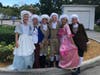 The cast in costume preparing for a skit about the Revolutionary War